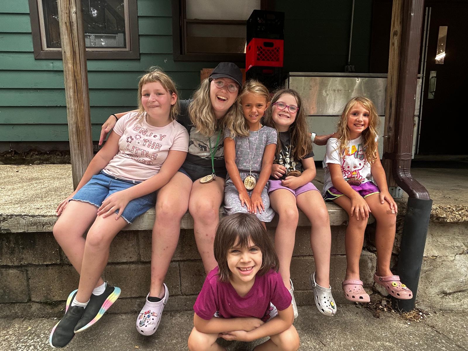 Campers with staff member on patio